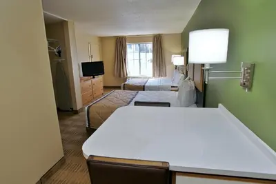 a hotel room with two beds and a television at Extended Stay America Suites - Fort Lauderdale - Davie in Davie