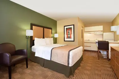 a hotel room with a bed and a desk and a chair at Extended Stay America Suites - Fort Lauderdale - Davie in Davie