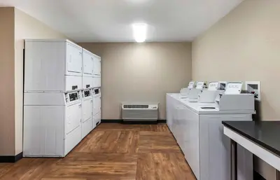 a kitchen with white appliances in a room at Extended Stay America Suites - Fort Lauderdale - Plantation in Plantation