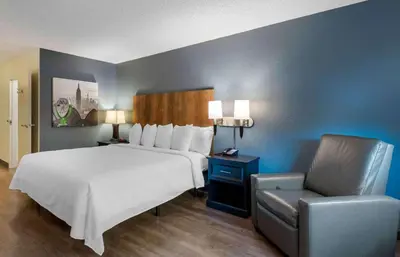 a bedroom with a large bed and a chair at Extended Stay America Premier Suites - Miami - Coral Gables in Miami