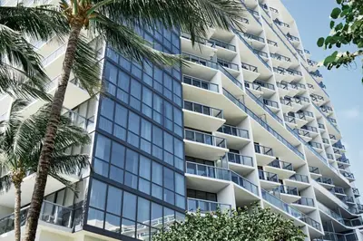 a tall building with palm trees in front of it at W South Beach in Miami Beach