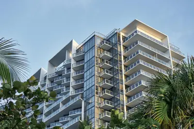 a tall building with palm trees in front of it at W South Beach in Miami Beach