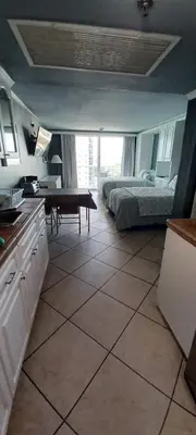 a kitchen with a bed and a table in a room at Miami Direct Access to the beach in Miami Beach