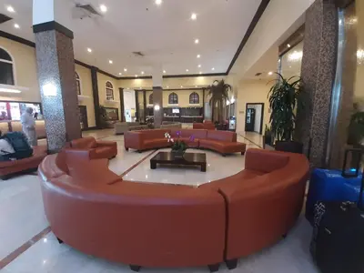 a lobby with a large couch and chairs in it at Miami Direct Access to the beach in Miami Beach