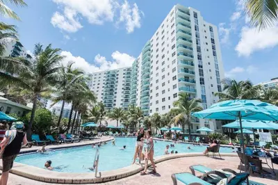 a pool at a resort with people in it at Miami Hollywood Condo for 4 People 001-21vic in Hollywood
