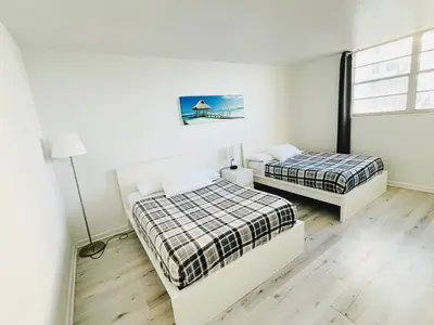 two beds in a room with white walls at Miami Hollywood Condo 2BD With Ocean View 005-21mar in Hollywood