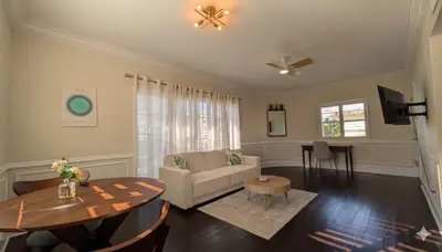 a living room with a couch and a table at La Casa Hotel in Fort Lauderdale