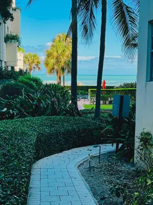 a walkway with a bench and palm trees and the ocean at Miami Hollywood Great 2 Bedroom with Garden View 001-22bmar in Hollywood