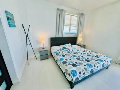 a bedroom with a bed with a blue and white comforter at Miami Hollywood Incredible 2 Bedroom 2 Bathroom 005-22bmar in Hollywood