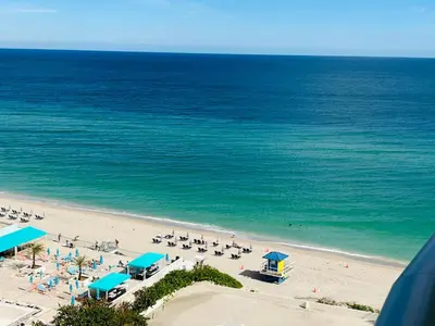 an overhead view of a beach with people and the ocean at Hallandale Beach Partial Ocean View Apartments in Hollywood