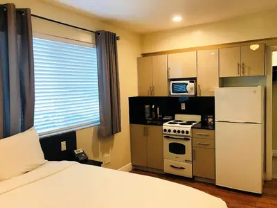 a small kitchen with a white refrigerator and a stove at Caribbean Resort Suites in Hollywood