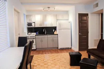 a kitchen with a white refrigerator and a table at Caribbean Resort Suites in Hollywood