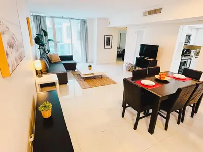 a living room with a table and a dining room at Miami Hollywood Bay View on the Beach 002-1bvic in Hollywood