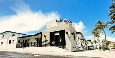 a white building with a sign on top of it at Hollywood Sunrise in Hollywood