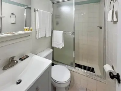a bathroom with a shower and a toilet and a sink at Hollywood Sunrise in Hollywood