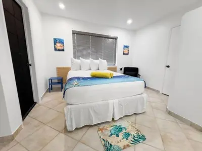 a bedroom with a bed with a yellow towel on it at Hollywood Sunrise in Hollywood