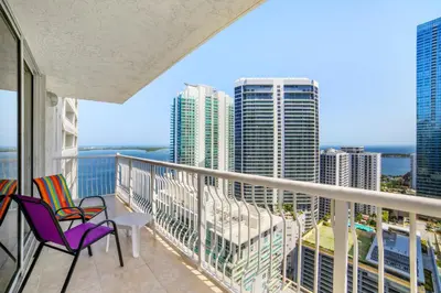 a balcony with chairs and a view of the city at Miami Downtown City view 3BR Air Hockey &Ping Pong table in Miami