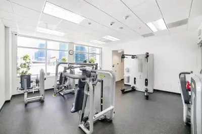 a gym with cardio equipment in a building at Miami Downtown City view 3BR Air Hockey &Ping Pong table in Miami
