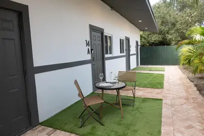 a patio with a table and chairs and a door at The Lauderdale Boutique Hotel in Fort Lauderdale