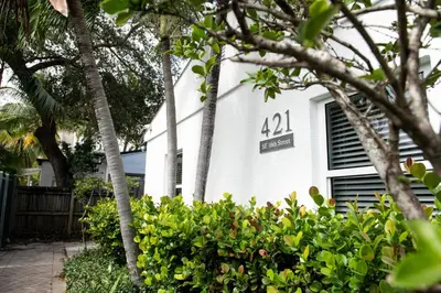 a white house with a sign on the side of it at The Lauderdale Boutique Hotel in Fort Lauderdale