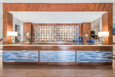 a lobby with a bar with a sign that reads the larder at The Landon Bay Harbor-Miami Beach in Miami Beach