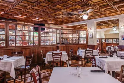 a dining room with white tables and chairs at The Landon Bay Harbor-Miami Beach in Miami Beach