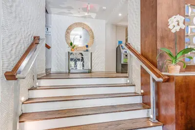 a staircase in a home with white and wood at The Landon Bay Harbor-Miami Beach in Miami Beach