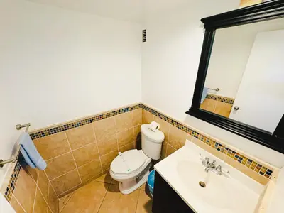 a bathroom with a toilet and a sink and a mirror at Miami Hollywood 2 Bedroom Garden View 001-21mar in Hollywood