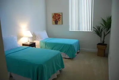 a room with two beds and a window at Dadeland Towers by Miami Vacations in South Miami