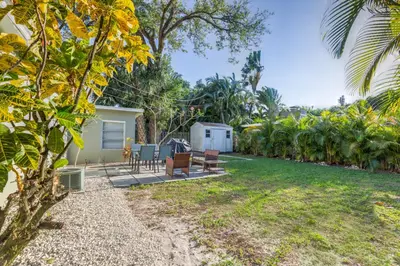 a backyard with a table and chairs and a house at The oasis near the cruise & airport - By Avi in Fort Lauderdale