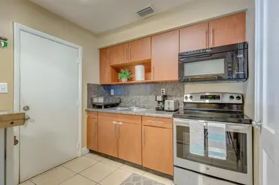 a kitchen with a stove and a microwave at The oasis near the cruise & airport - By Avi in Fort Lauderdale