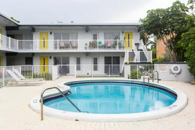 a swimming pool in front of a building at Spectacular view on the canal, Fort Lauderdale, very clean, free Parking & Wifi in Fort Lauderdale