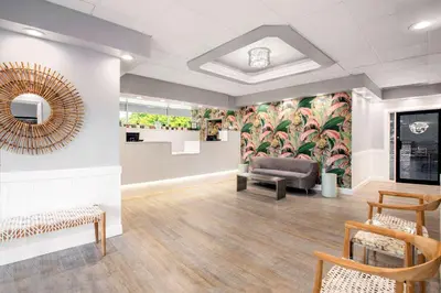 a waiting room with a chair and a couch at Quality Inn Miami South in Kendall