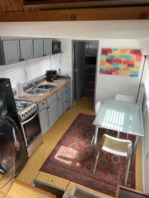 a small kitchen with a table and a sink at Updated houseboat on the river! in Fort Lauderdale