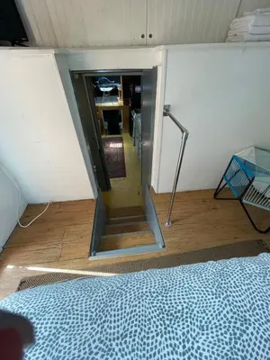 a view of a room with a bed and a hallway at Updated houseboat on the river! in Fort Lauderdale