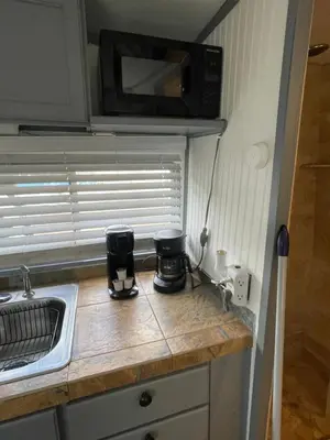 a kitchen with a counter top with a microwave at Updated houseboat on the river! in Fort Lauderdale