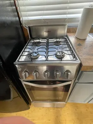 a stove top oven sitting on top of a kitchen counter at Updated houseboat on the river! in Fort Lauderdale