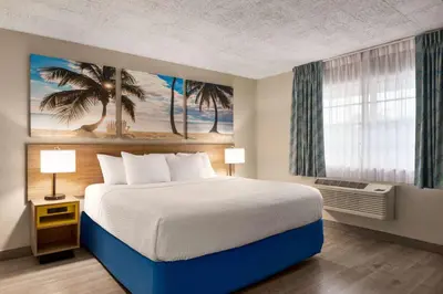 a bedroom with a large bed and a window at Days Inn by Wyndham Miami Airport North in Miami