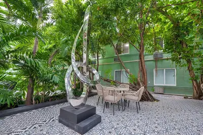 a glass sculpture in front of a table and chairs at Atrium Hotel, Trademark Collection by Wyndham in Miami