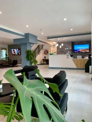 a lobby with a waiting room with chairs and a table at Atrium Hotel, Trademark Collection by Wyndham in Miami