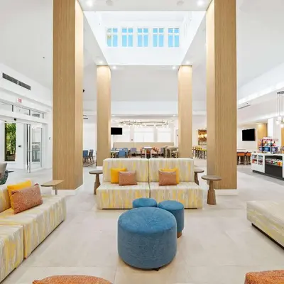 a lobby with couches and chairs and a table at Hilton Garden Inn Ft. Lauderdale Airport-Cruise Port in Dania Beach