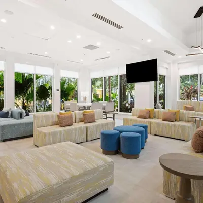 a living room with couches and a flat screen tv at Hilton Garden Inn Ft. Lauderdale Airport-Cruise Port in Dania Beach