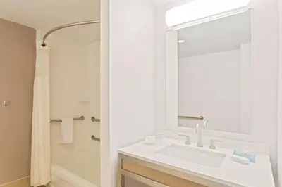 a white bathroom with a sink and a shower at Hilton Garden Inn Ft. Lauderdale SW/Miramar in Miramar