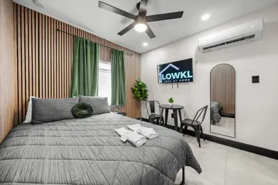 a bedroom with a bed and a table with chairs at Baybreeze Apartments by Lowkl in Miami Beach
