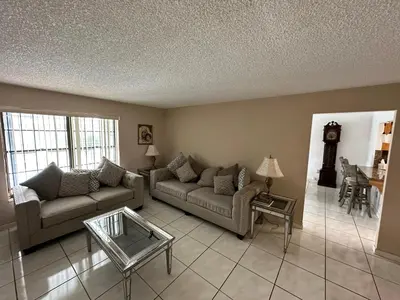 a living room with two couches and a table at 82-10SW 135AV in Miami