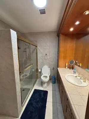a bathroom with a toilet and a shower and a sink at 82-10SW 135AV in Miami