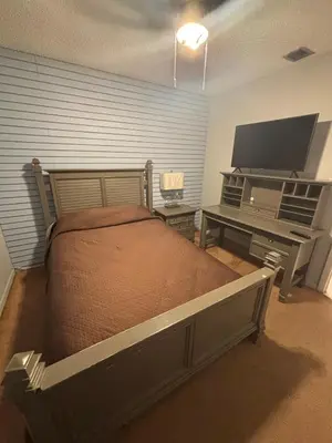 a bedroom with a bed and a flat screen tv at 82-10SW 135AV in Miami