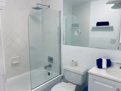 a bathroom with a shower and a toilet and a sink at Beachfront Ocean Dr white sand paradise SoBe 311 in Miami Beach