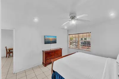 a bedroom with a bed and a ceiling fan at The Palms in Hollywood