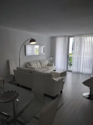 a living room with a couch and a table at Tides Apt on Hollywood Beach in Hollywood
